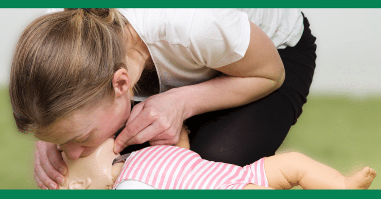 woman gives cpr to baby mannequin